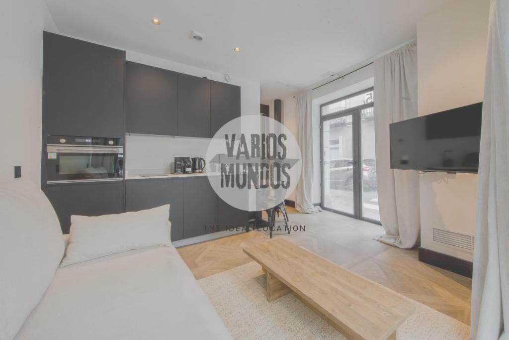 a bedroom with a white bed and a wooden table at Magia Madrileña para 4 en Calle del Aguila E3 in Madrid