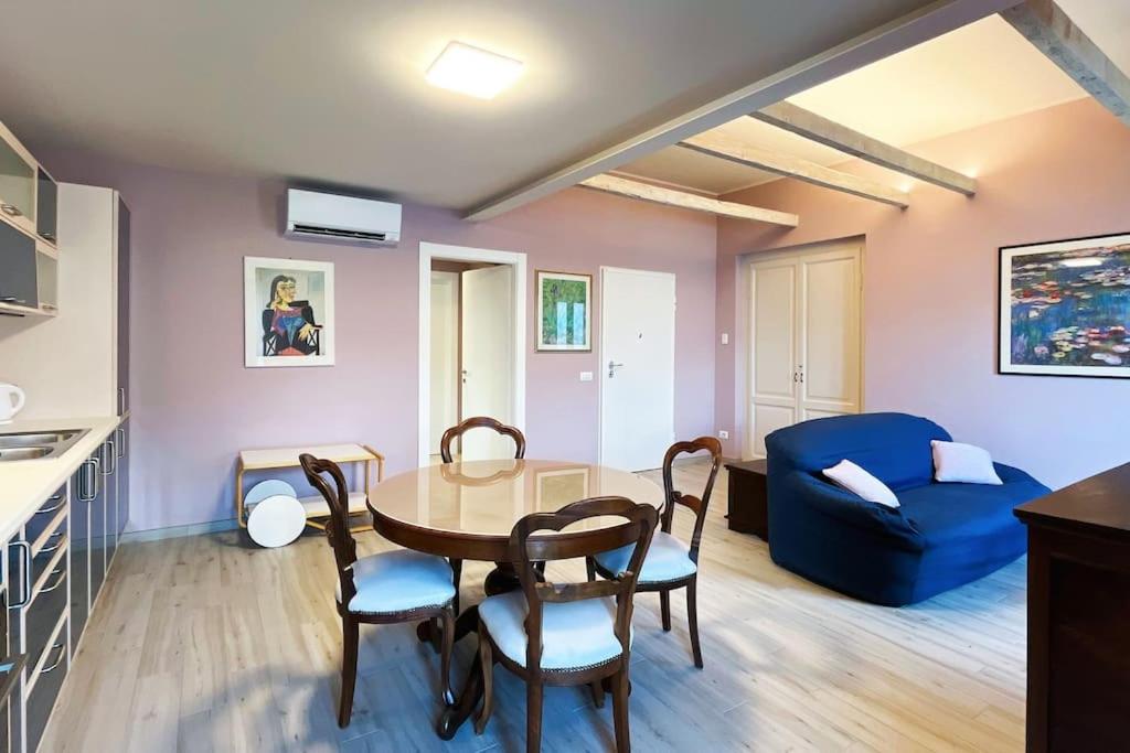 a living room with a table and a blue couch at Gio House - Affitti Brevi Italia in Onno
