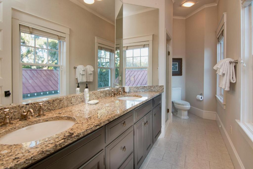 a bathroom with two sinks and a large mirror at 5 Bedroom Wilson Village Home 33 in Bluffton