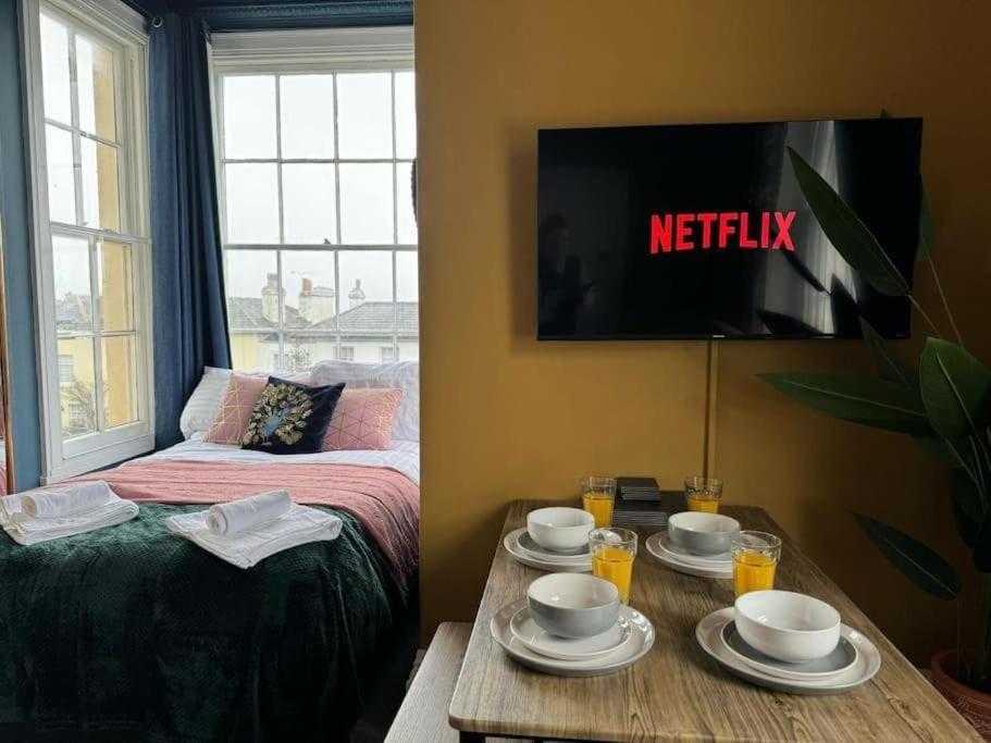 a room with a bed and a table with dishes on it at Ryde view Studio in Isle of Wight
