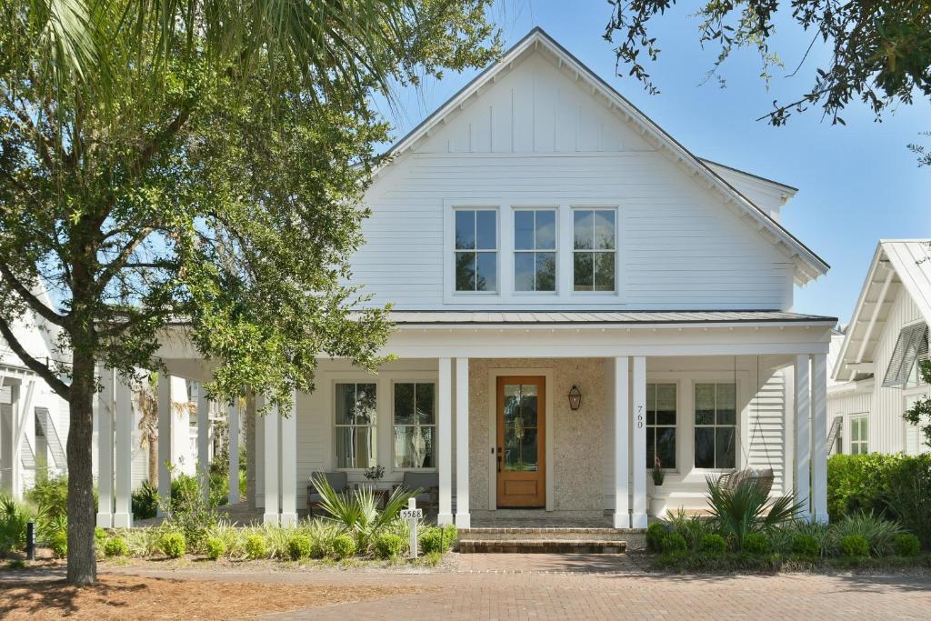 a white house with a yellow door at 3 Bedroom Moreland Village Home 5588 in Bluffton