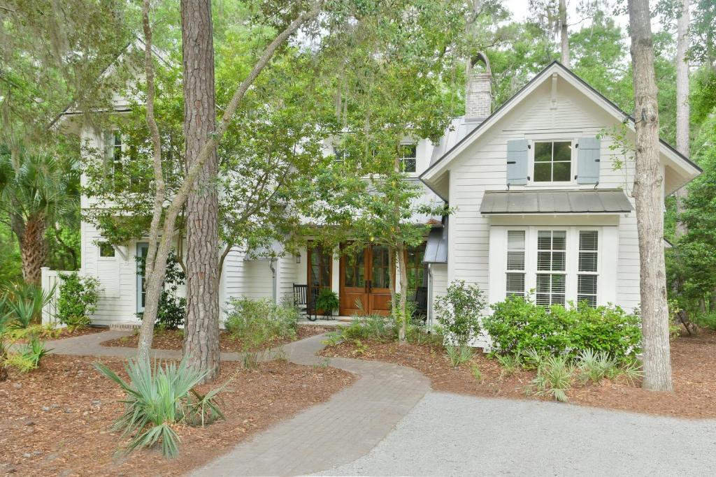 a white house with trees in front of it at Lagoon 3 Bedroom Wilson Village Home 128 in Bluffton