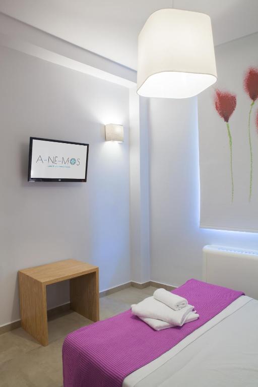 Postel nebo postele na pokoji v ubytování Anemos Rooms & Apartments