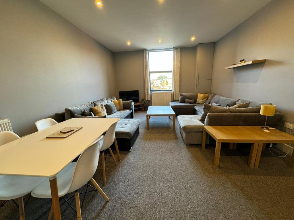 a living room with a couch and a table at 1 bed Apt close to Leeds Arena Sleeps up to 4 people F1 in Leeds
