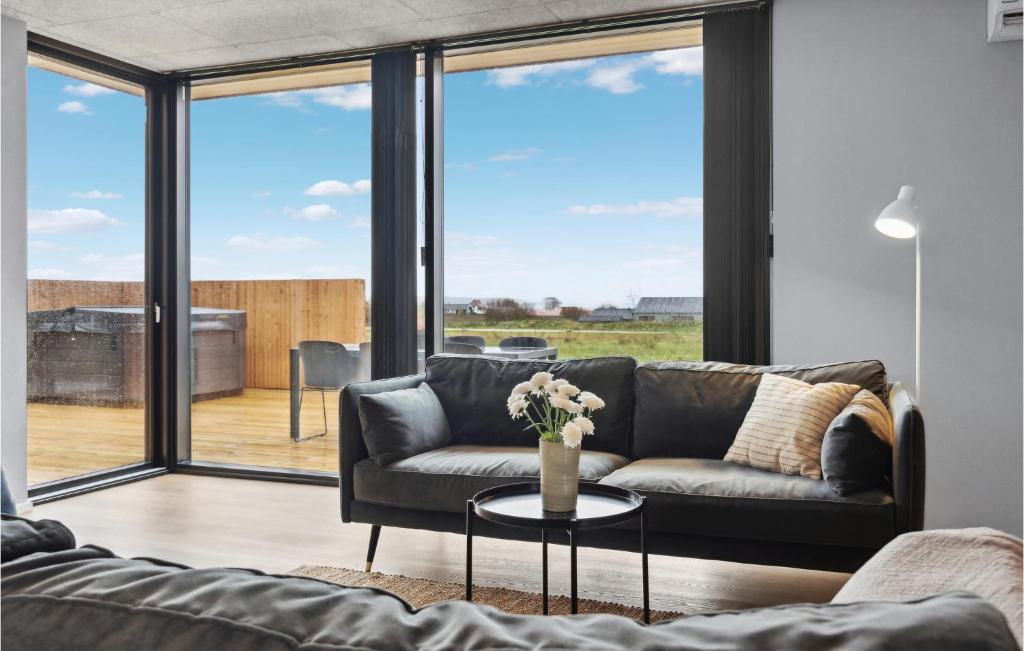 a living room with a couch and a table at Amazing Home In Børkop With Sauna in Børkop