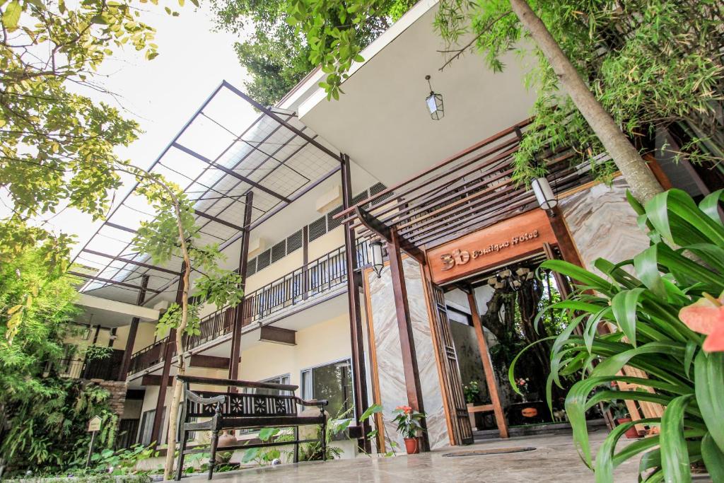 an external view of a building with a balcony at 3B Boutique Hotel in Chiang Mai