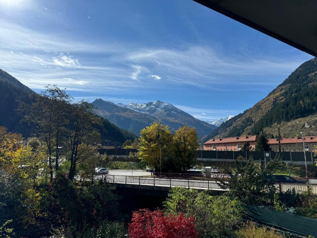 a bridge over a road with mountains in the background at Stubnerkogel Apartments in Bad Gastein