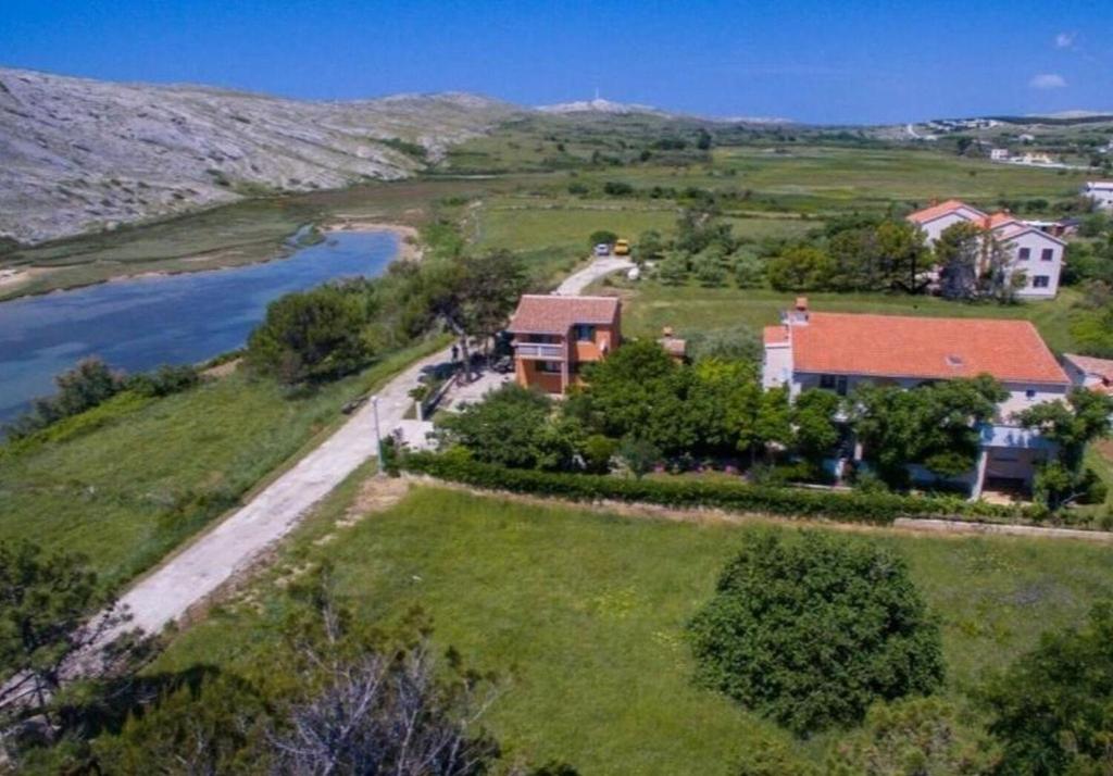 an aerial view of a house on a hill next to a river at Apartments Ana in Vlašići