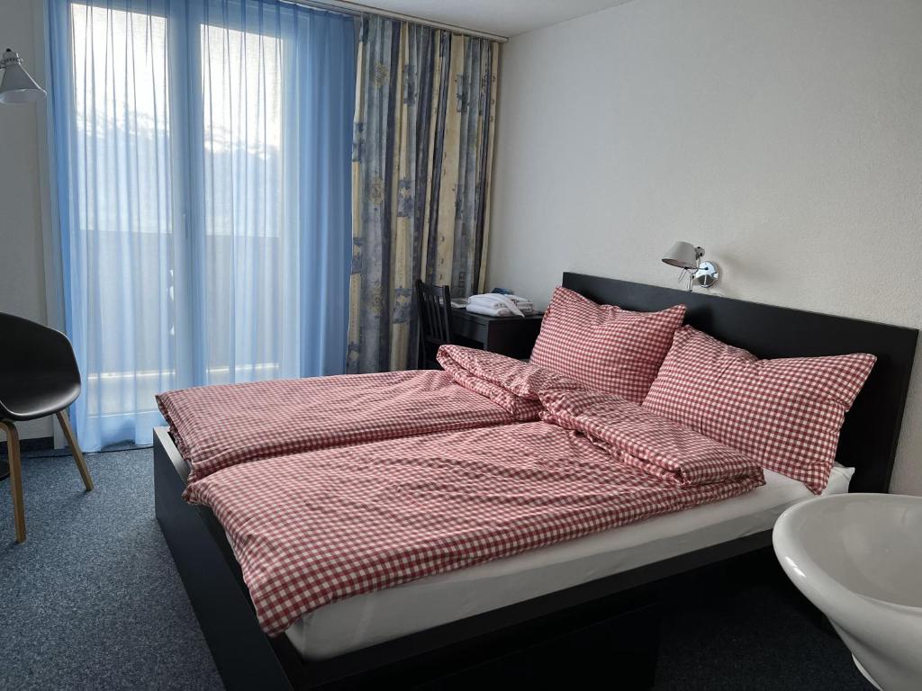 Postel nebo postele na pokoji v ubytování Guesthouse Sonnegg