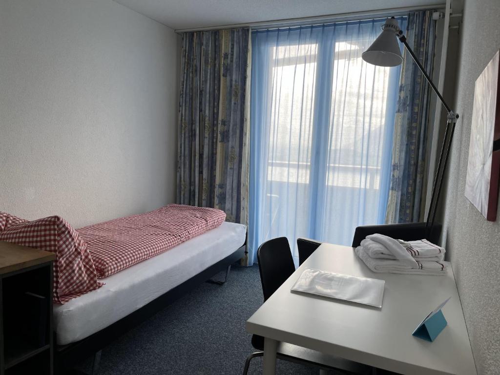 Postel nebo postele na pokoji v ubytování Guesthouse Sonnegg