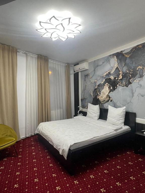 Postel nebo postele na pokoji v ubytování Hotel EvoZava Central