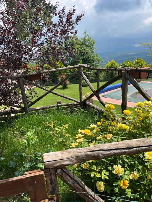 a wooden fence next to a field of flowers at Villa Alce in Fontanarosa