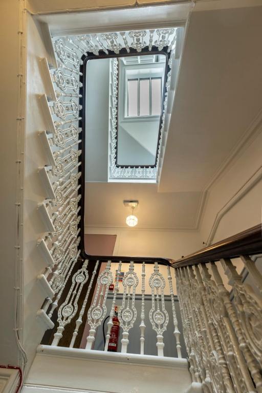 a mirror on the ceiling of a room with a staircase at 8QR Rooms in Aberdeen