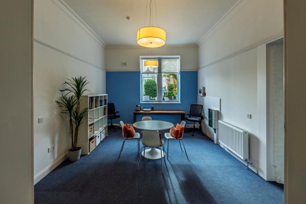 an office with a table and chairs and a window at 8QR Rooms in Aberdeen