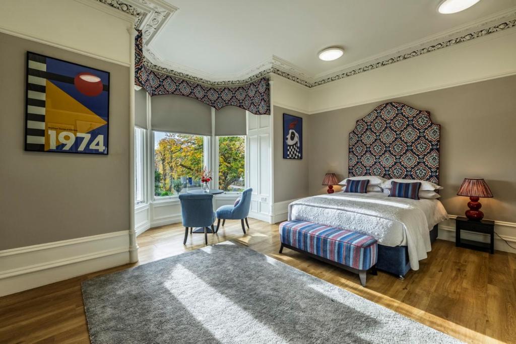 a bedroom with a bed and a large window at 8QR Rooms in Aberdeen
