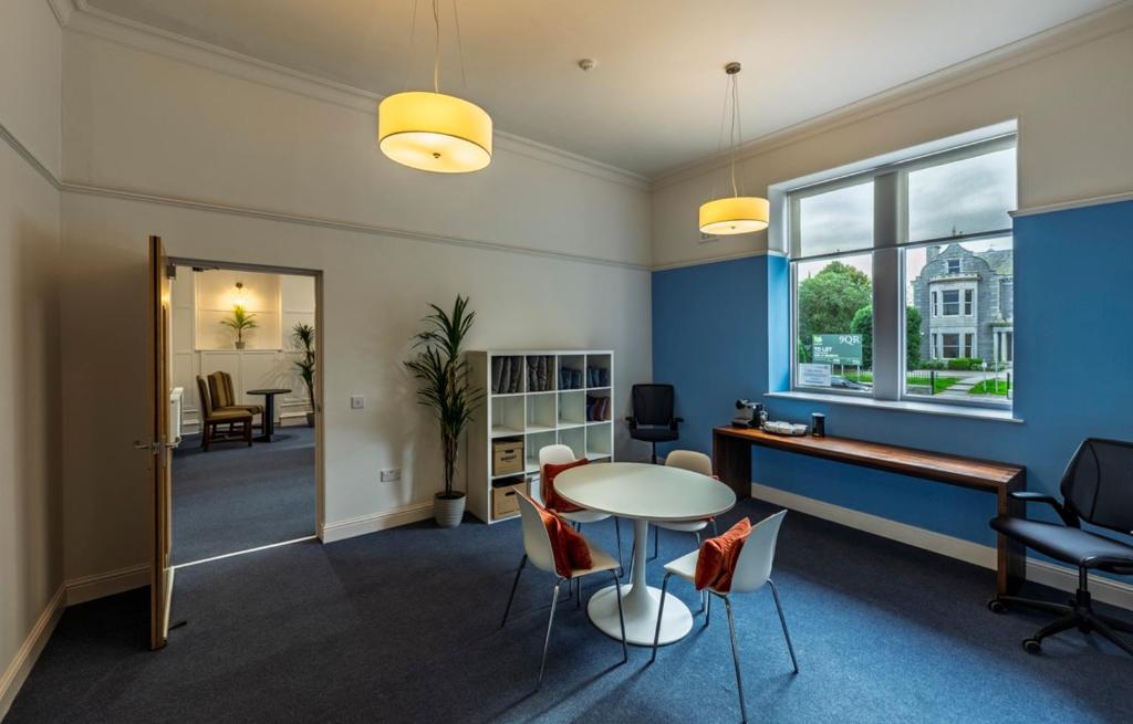 an office with a table and chairs and a window at 8QR Rooms in Aberdeen