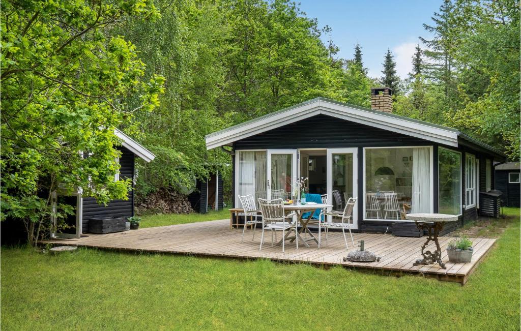 a gazebo with a table and chairs on a deck at Amazing Home In Rørvig With Kitchen in Rørvig