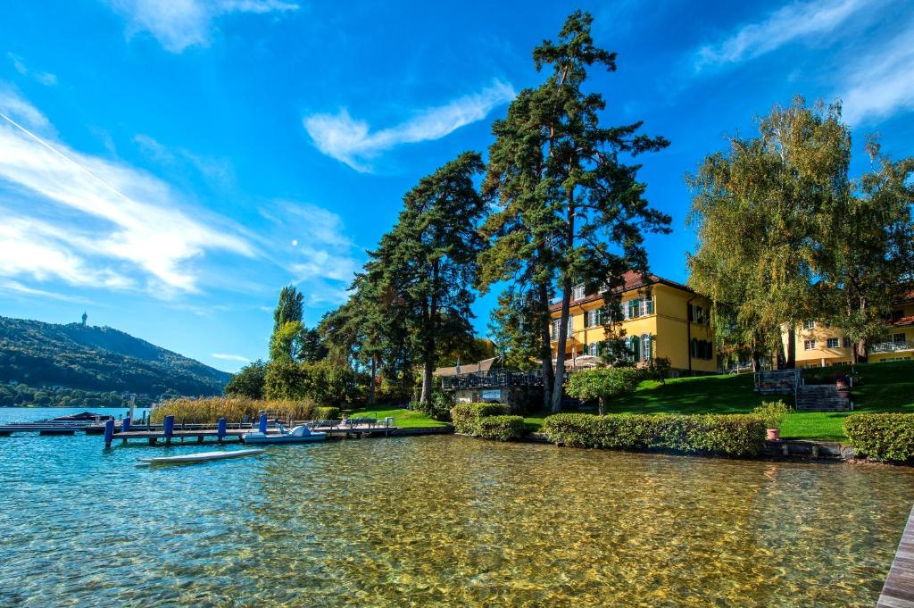 a view of a lake with boats in the water at Hotel Villa Rainer in Pörtschach am Wörthersee