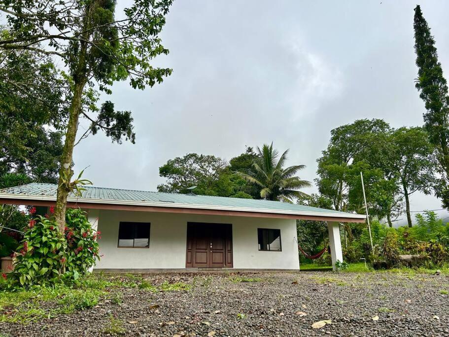 a small white house with a tree in front of it at Miravalles Country House in Guayabal