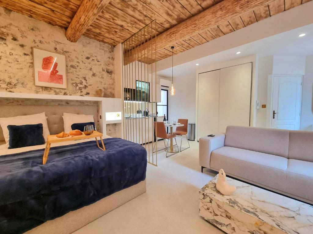 una camera da letto con un letto e un divano di 25 rue Celony - Le Vendome - Jacuzzi - VideoProjecteur ad Aix en Provence