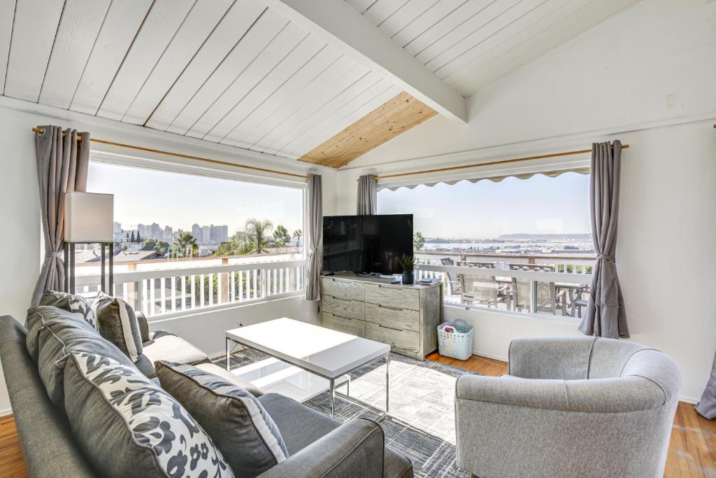 a living room with a couch and a tv at 3 Mi to Balboa Park Water-View Condo with Balcony in San Diego