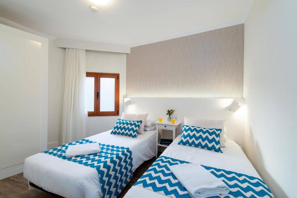 Postel nebo postele na pokoji v ubytování Villa Lobos by Villa Plus