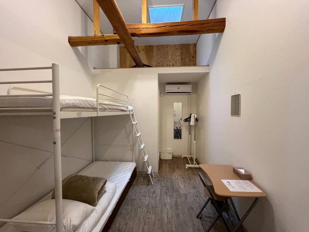 a small room with bunk beds and a desk at K-style Nishijin backpackers - Vacation STAY 17740 in Kyoto