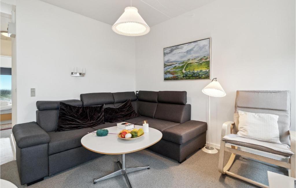 a living room with a couch and a table at Fanø Bad, Lejl 74 in Fanø