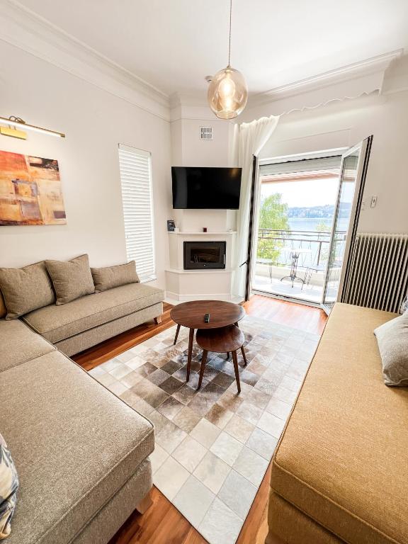 a living room with a couch and a table at CASA BIANCA Kastoria in Kastoria