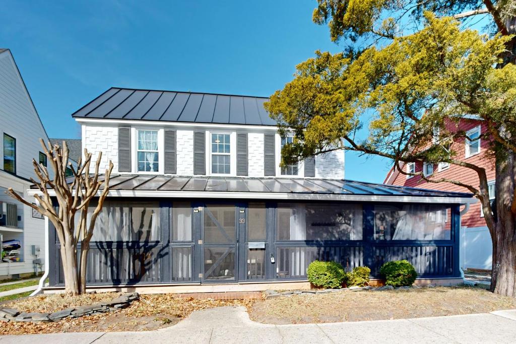 a white house with a black roof at Town of Rehoboth Beach --- 33 Maryland Ave in Rehoboth Beach