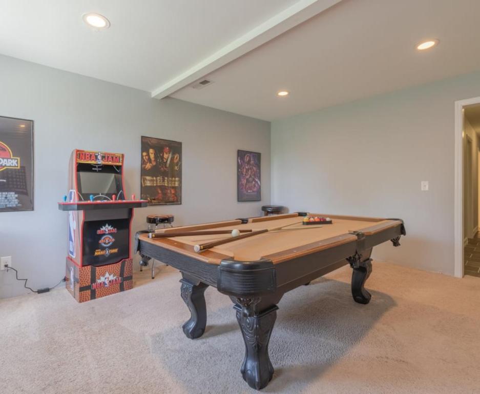 a pool table in a room with a tv at Hot Tub, Views & Game Room - 20 min to Downtown Asheville! in Mars Hill