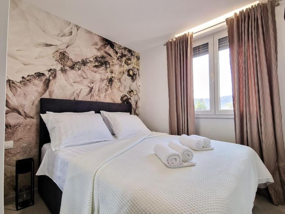 a bedroom with a bed with towels on it at MonLux studio- FREE Public Parking-Easy Walk to the Center in Split