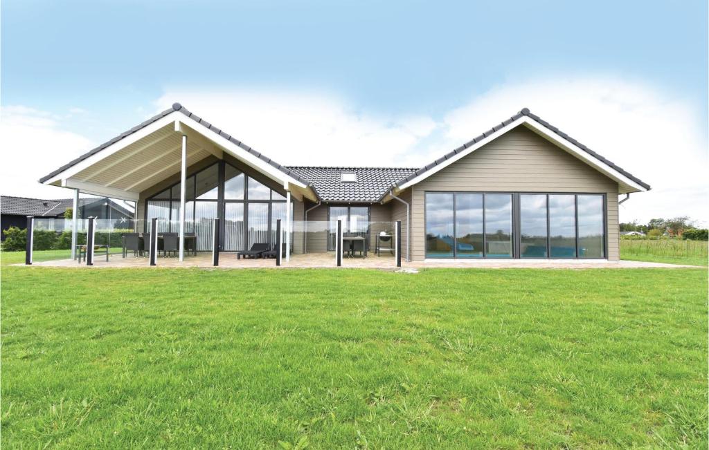a house with a large lawn in front of it at Beautiful Home In Otterup With Sauna in Otterup