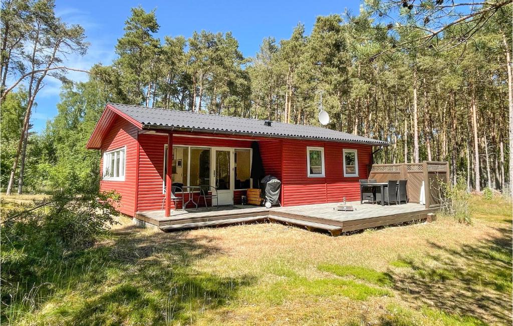a red tiny house in the middle of a field at Nice Home In Aakirkeby With Wifi in Vester Sømarken