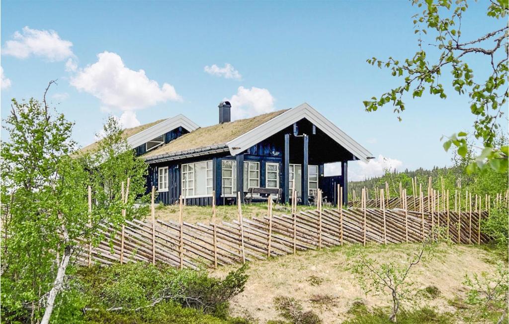 a house with a fence in front of it at Nice Home In Veggli With Wifi in Veggli