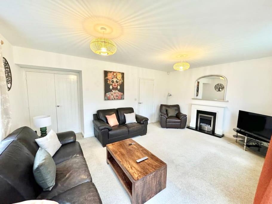 a living room with two couches and a coffee table at Unique Stays Modern Evergreen House in Ashford! in Ashford