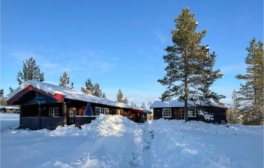 a house covered in snow with a pile of snow at 5 Bedroom Pet Friendly Home In Jordet in Jordet