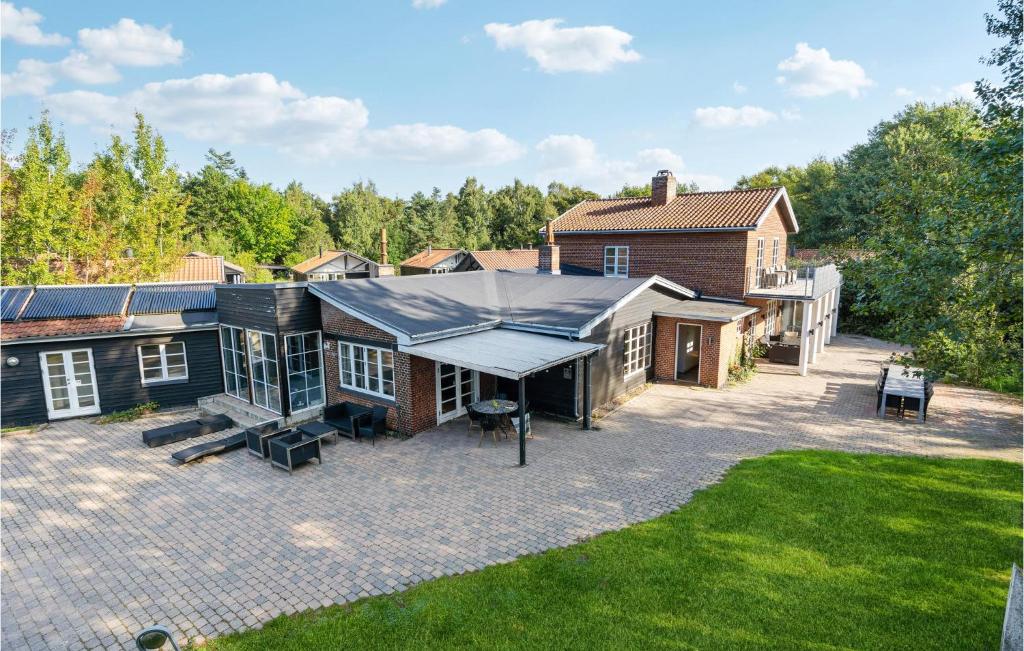 an aerial view of a house with a roof at Amazing Home In Væggerløse With Sauna in Marielyst