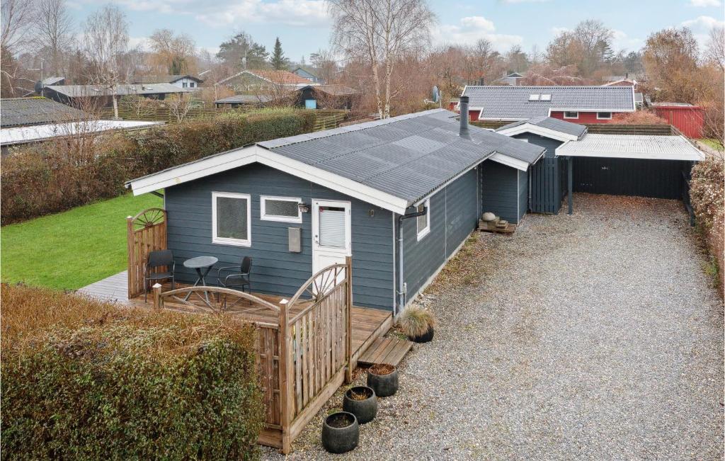 a blue tiny house with a porch and a yard at Nice Home In Slagelse With Wifi in Slagelse