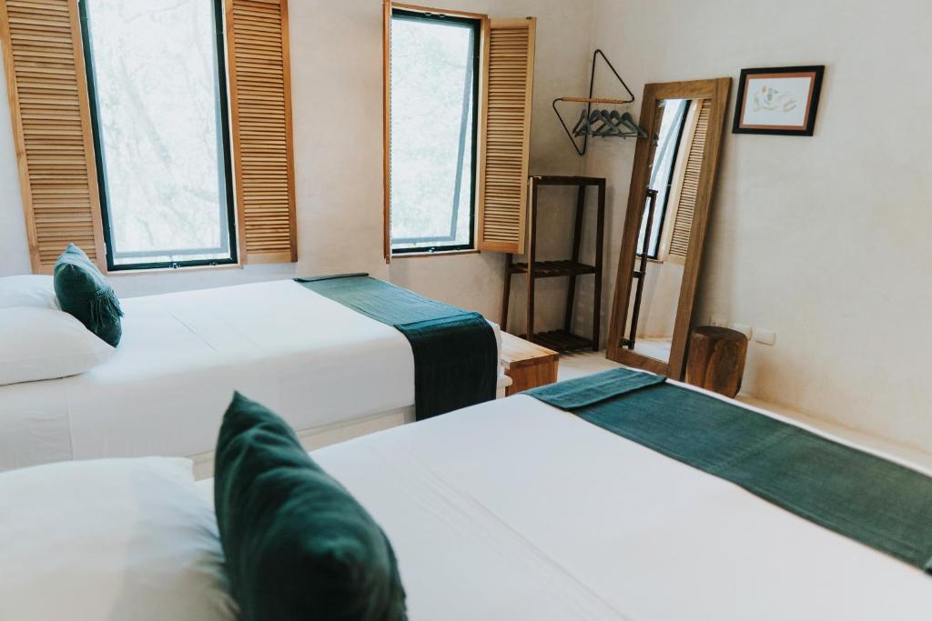 Postel nebo postele na pokoji v ubytování Koos Tulum Hotel