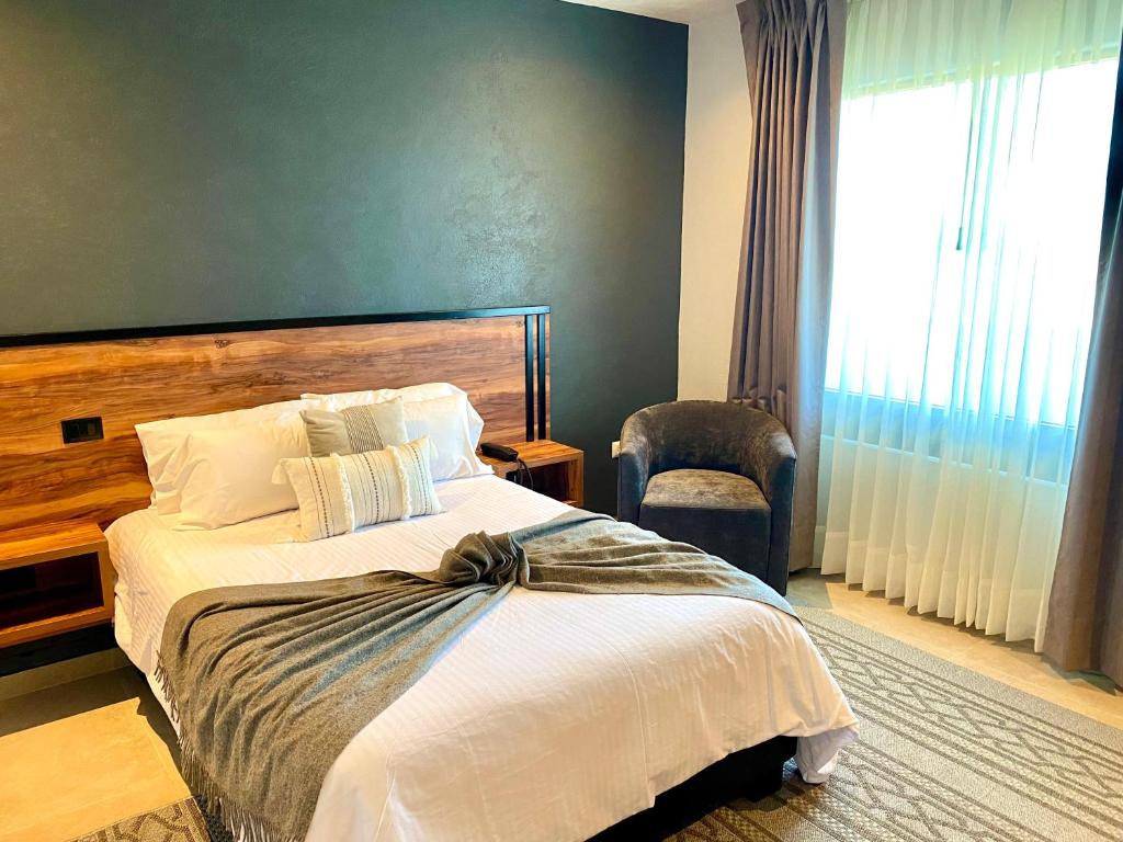 Postel nebo postele na pokoji v ubytování HOTEL MINA REAL MATEHUALA