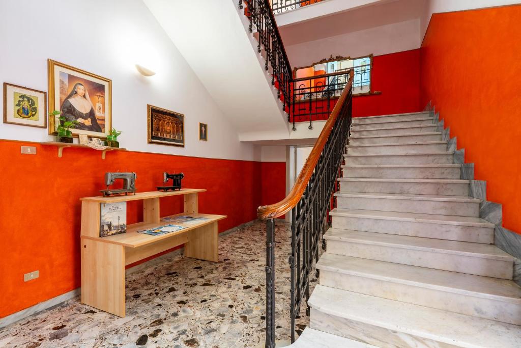 a staircase in a home with orange walls at Casa di Madre Antonia in Brindisi