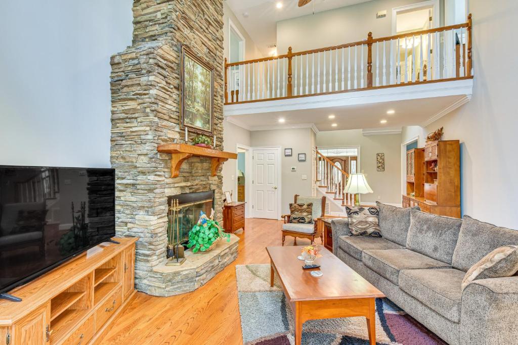 a living room with a couch and a fireplace at Lakefront Hartwell Retreat with Gas Grill and Deck! in Hartwell