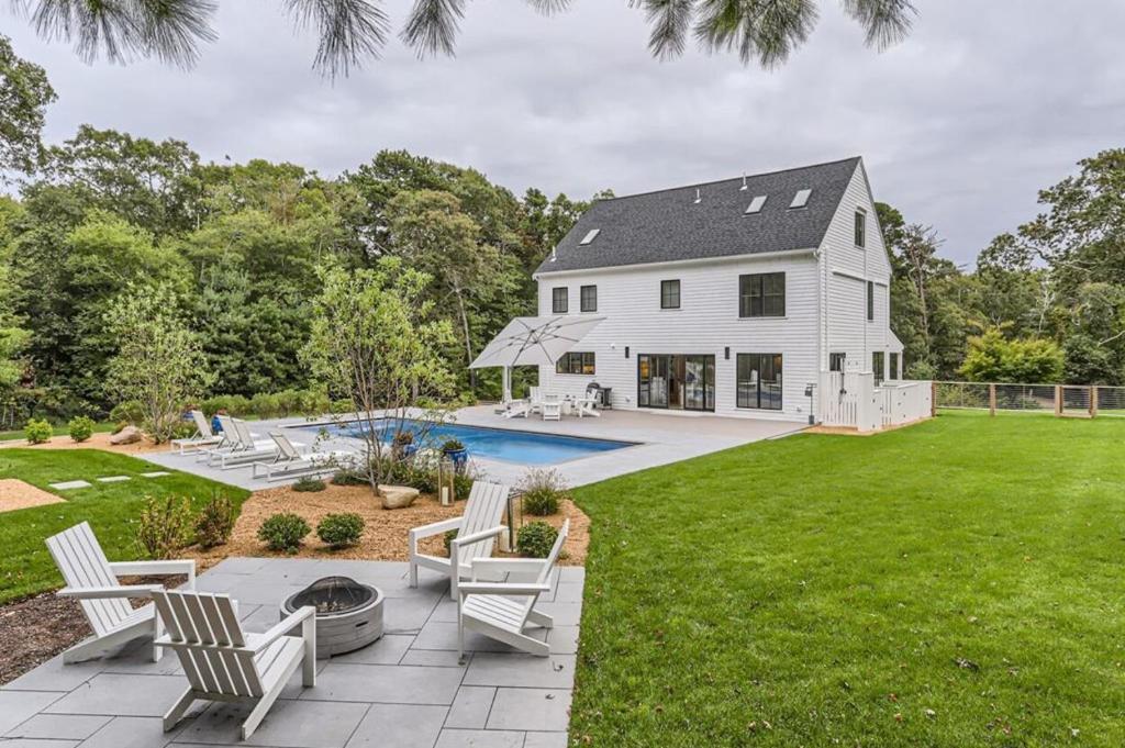 a white house with a patio and a pool at Vineyard Haven Retreat With Pool & Guest House Oasis in Big Rock