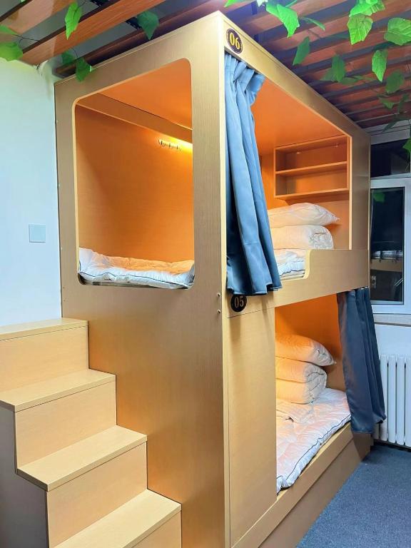 Postel nebo postele na pokoji v ubytování Zhihexing Youth Hostel-知和行青年酒店