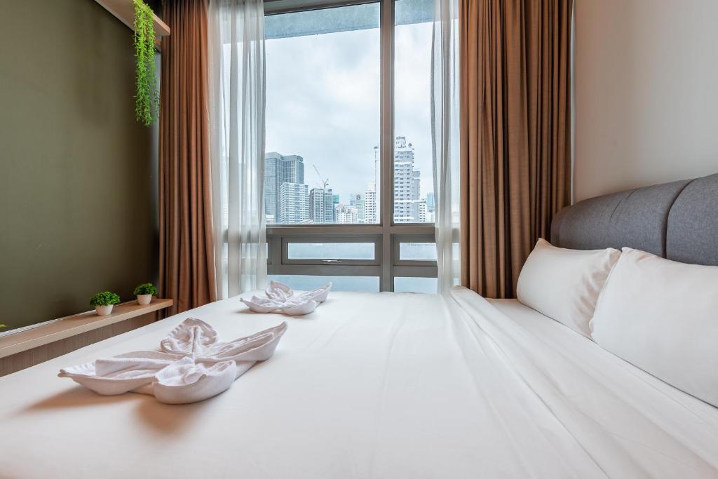 a bedroom with a large white bed with a window at No Other Fee #Swiss Garden Residences by The Boston House #Bukit Bintang in Kuala Lumpur