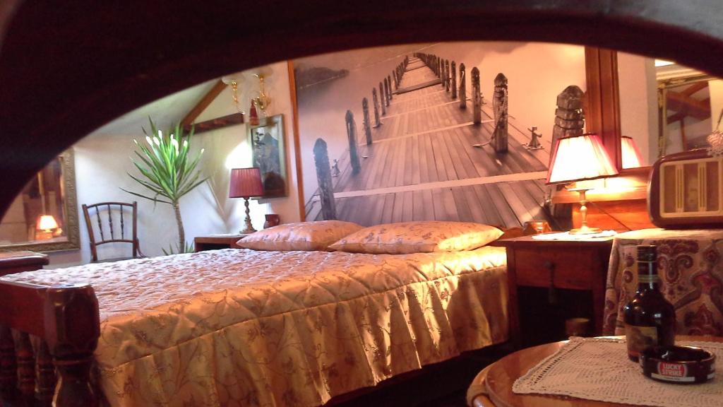 a bedroom with a bed with a painting on the wall at Studios Kono in Kotor