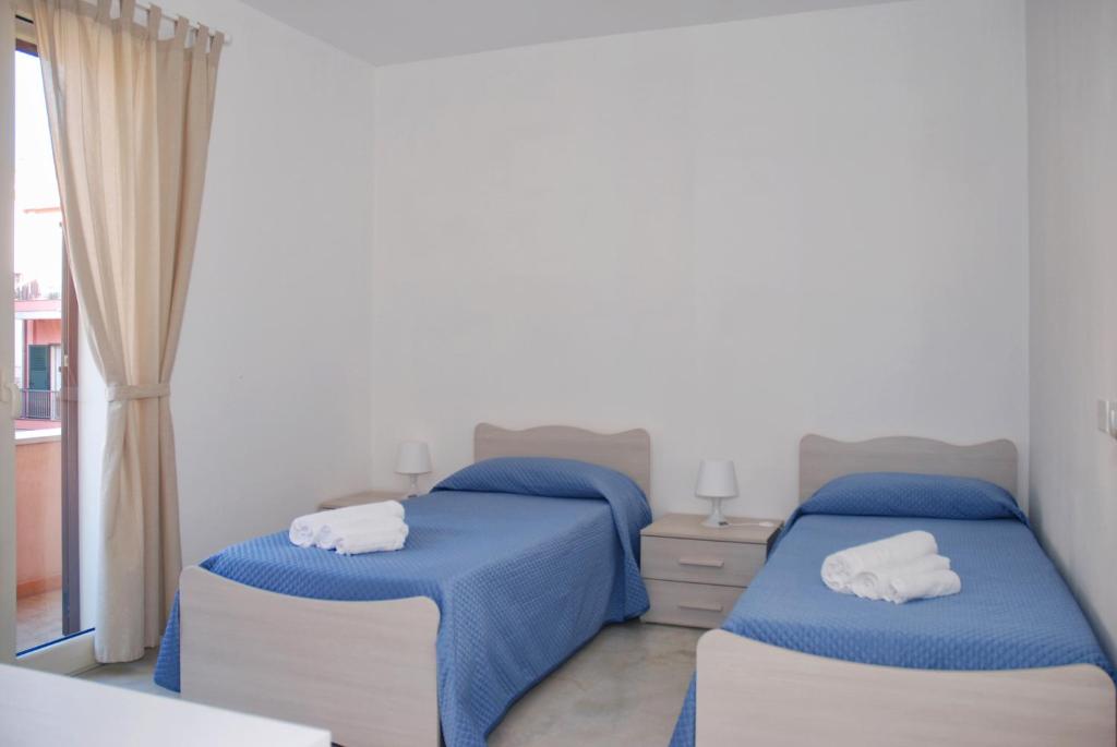 Postel nebo postele na pokoji v ubytování B&B Sikelia