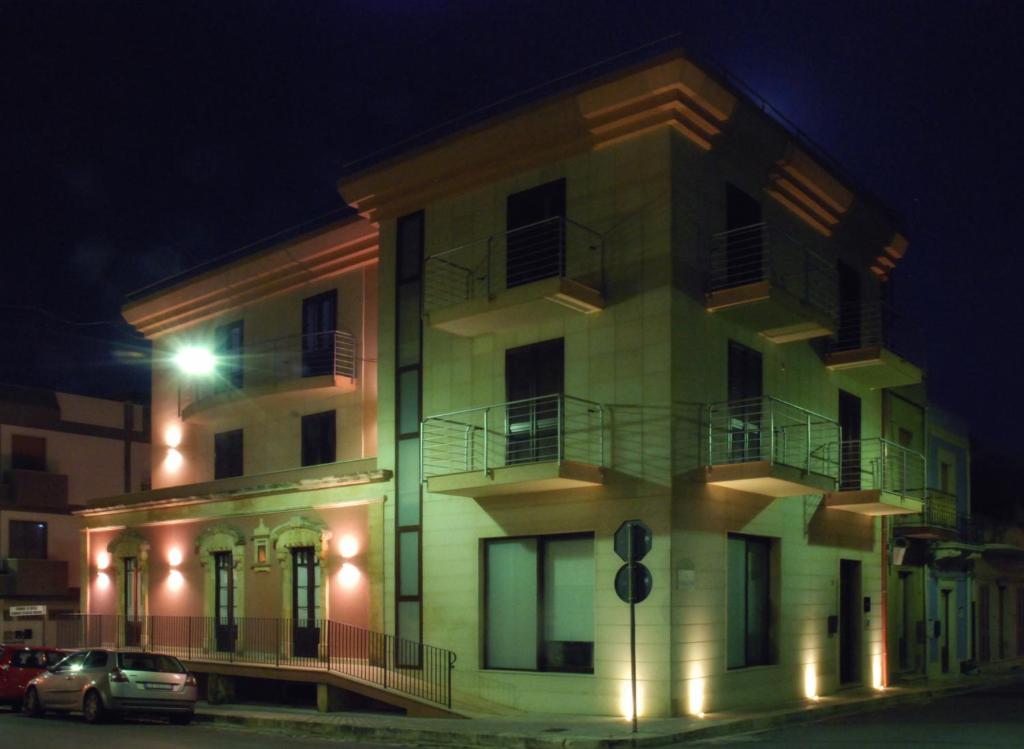 a building with cars parked in front of it at night at B&B Sikelia in Ispica