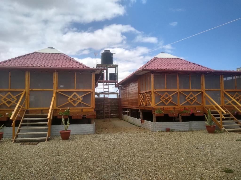 a couple of buildings sitting next to each other at Somos la experiencia LaCruzHouse in Paita